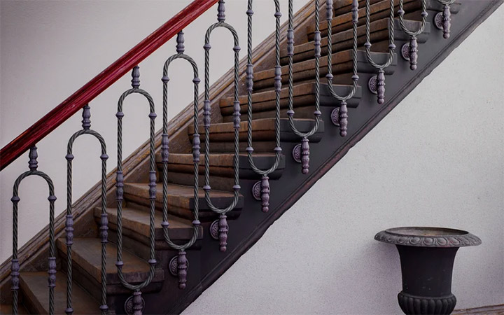 Wood and beautifully detailed wrought iron stair railing design