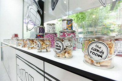 Candy jars lined on the counter of a charming black-and-white shop