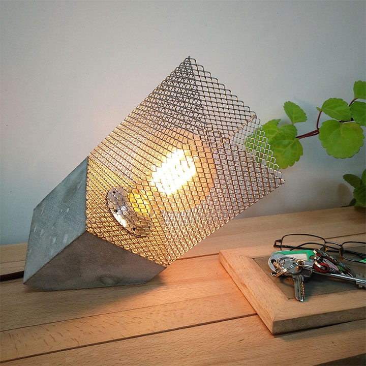 Charming light fixture with concrete base and metal mesh lampshade