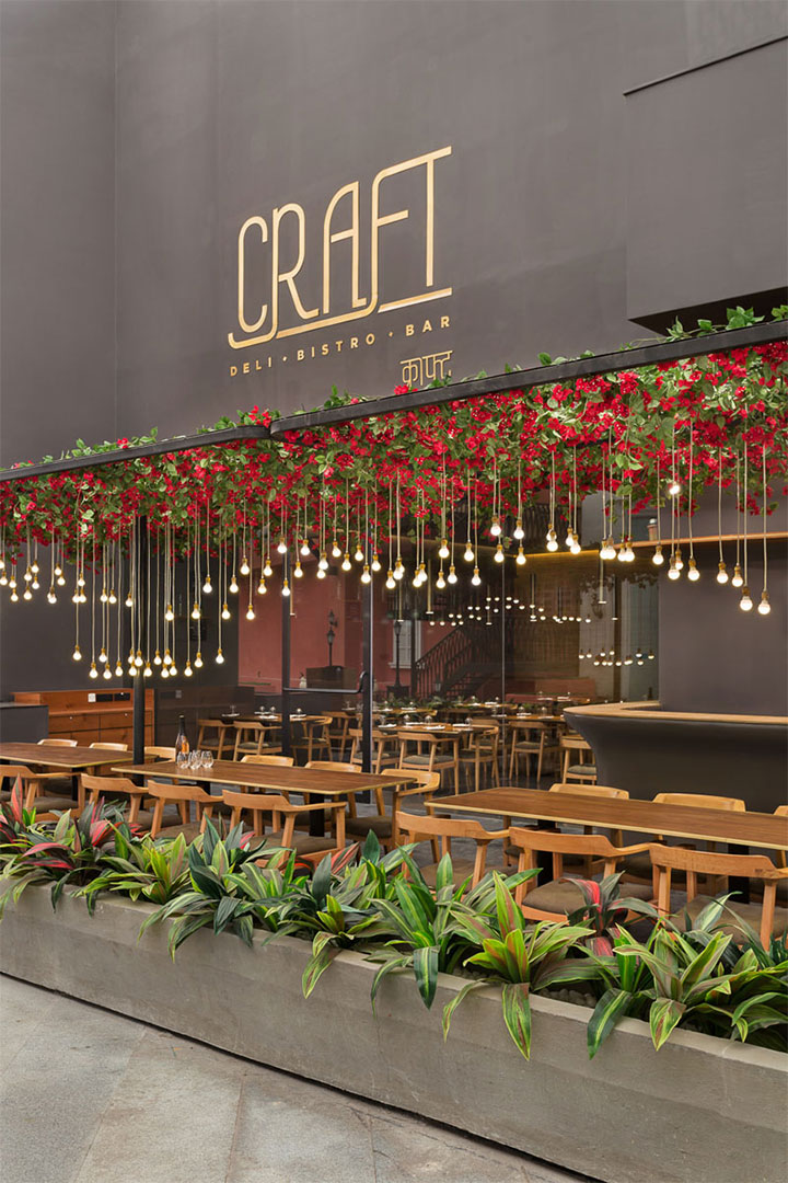 Flowers and green plants in open dining area of the restaurant