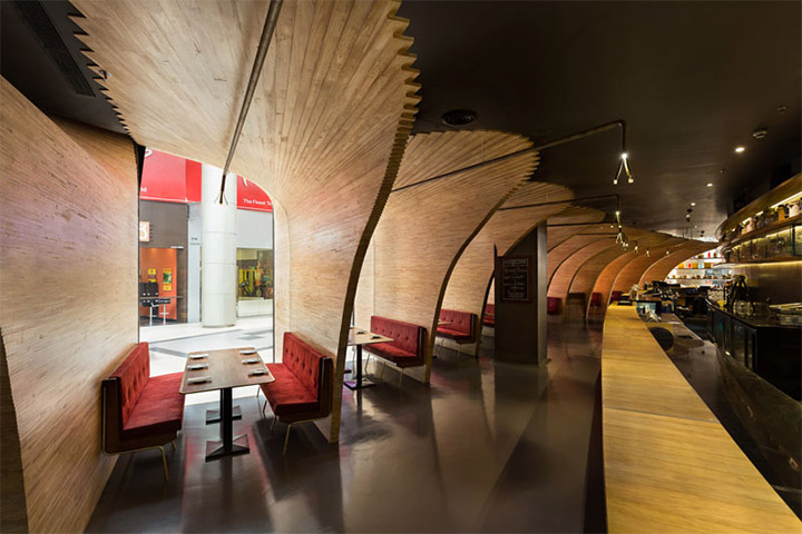 Large curved wood structures acting as dividers in modern restaurant interior