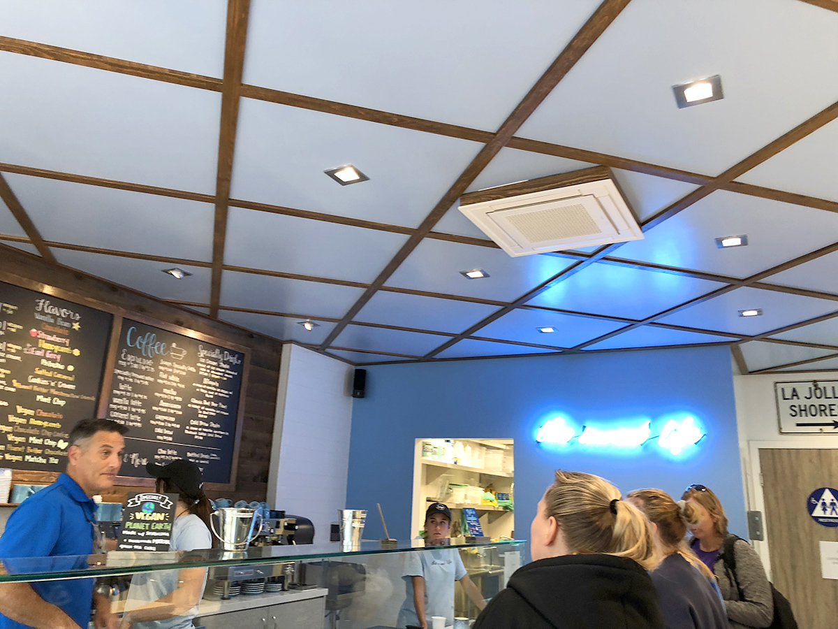 Finished ice-cream store design with wooden ceiling accents
