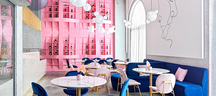 Pink shelf and blue upholstery in restaurant dining area