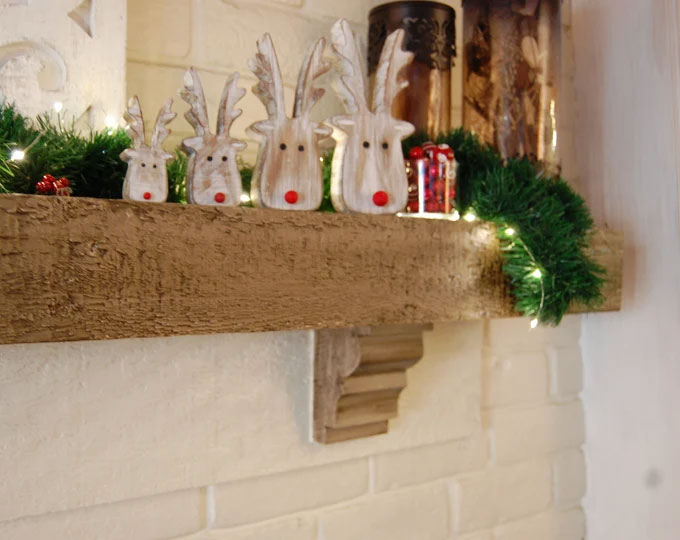 Wooden reindeer accents on mantel