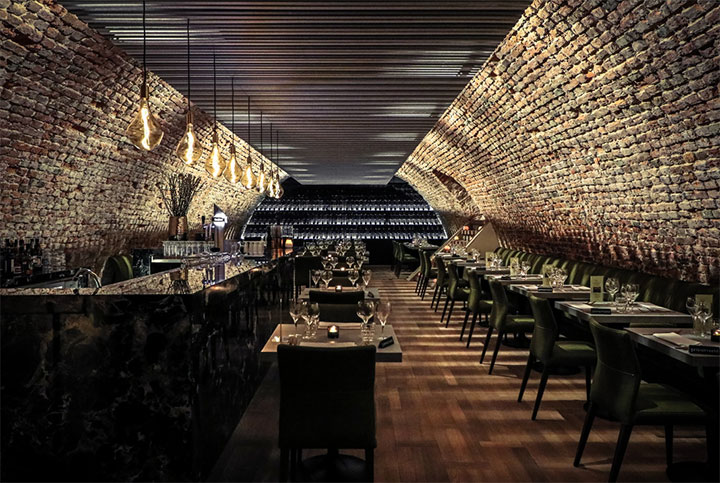 Intimate restaurant with brick walls and felt ceilings