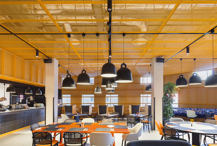 Yellow stretch metal ceiling in urban restaurant