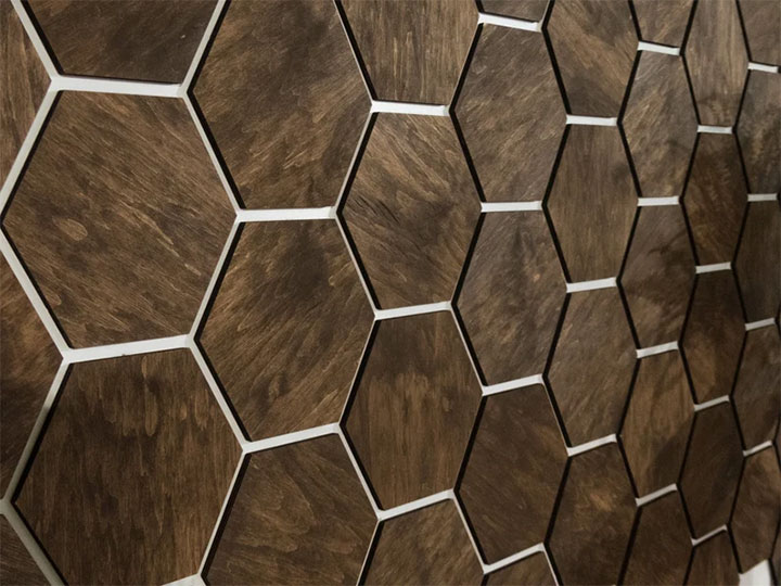 Dark hexagonal wood panels that make walls pop