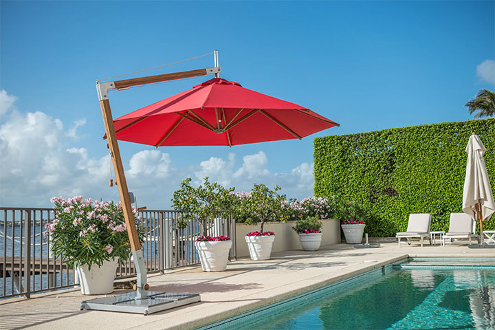Small cantilever umbrella with bamboo pole and red canopy