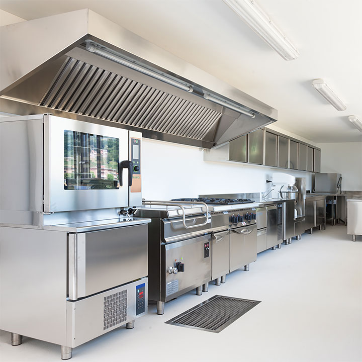Heavy-duty appliances in restaurant kitchen, including a commercial kitchen hood