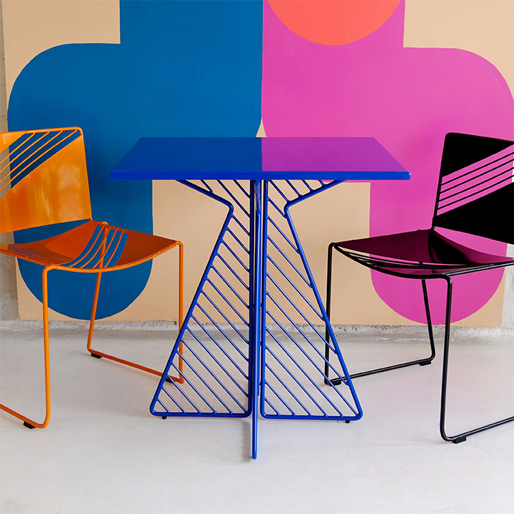 Fun seating and table against colorful wall