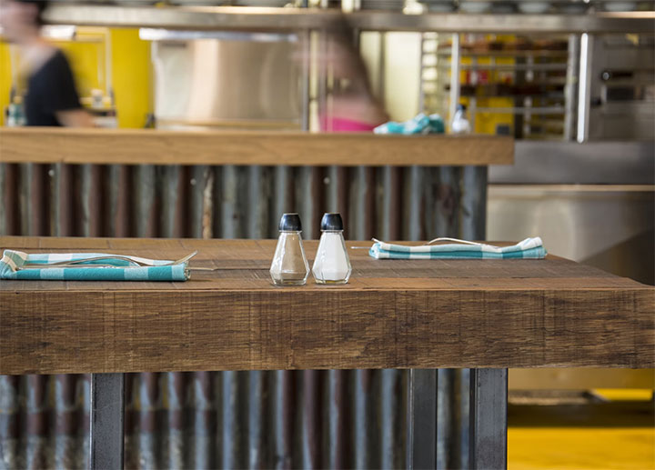 Butcher block table and counter in a small restaurant.