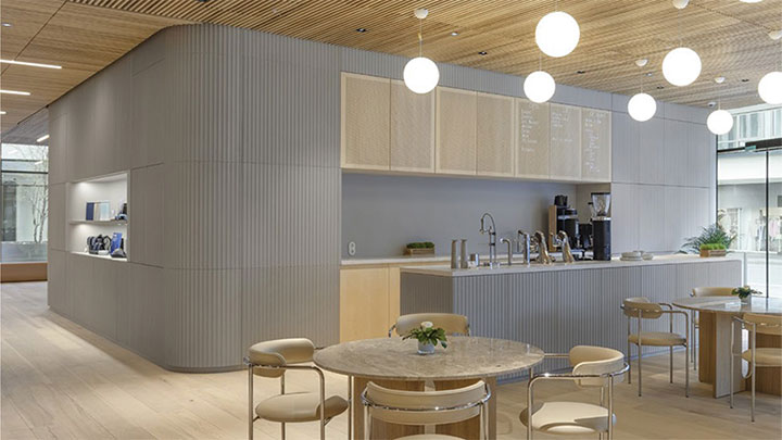 Fluted concrete sheet used as a wall treatment in a cafeteria.
