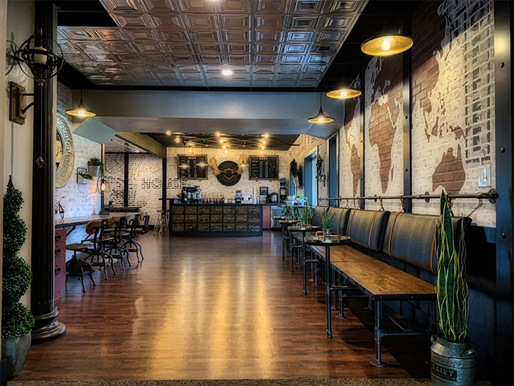 Dark hardwood floors in spacious cafe.