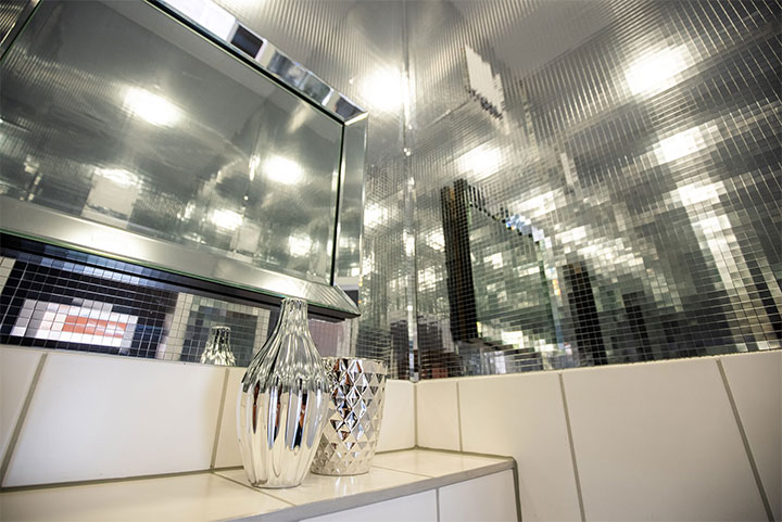 Walls dressed in silver disco-ball decorative panels. 