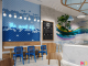 Large fish-scale wall pattern as a focal point in a beach-inspired ice-cream shop