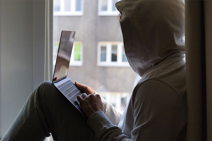Hacker looking at a website.