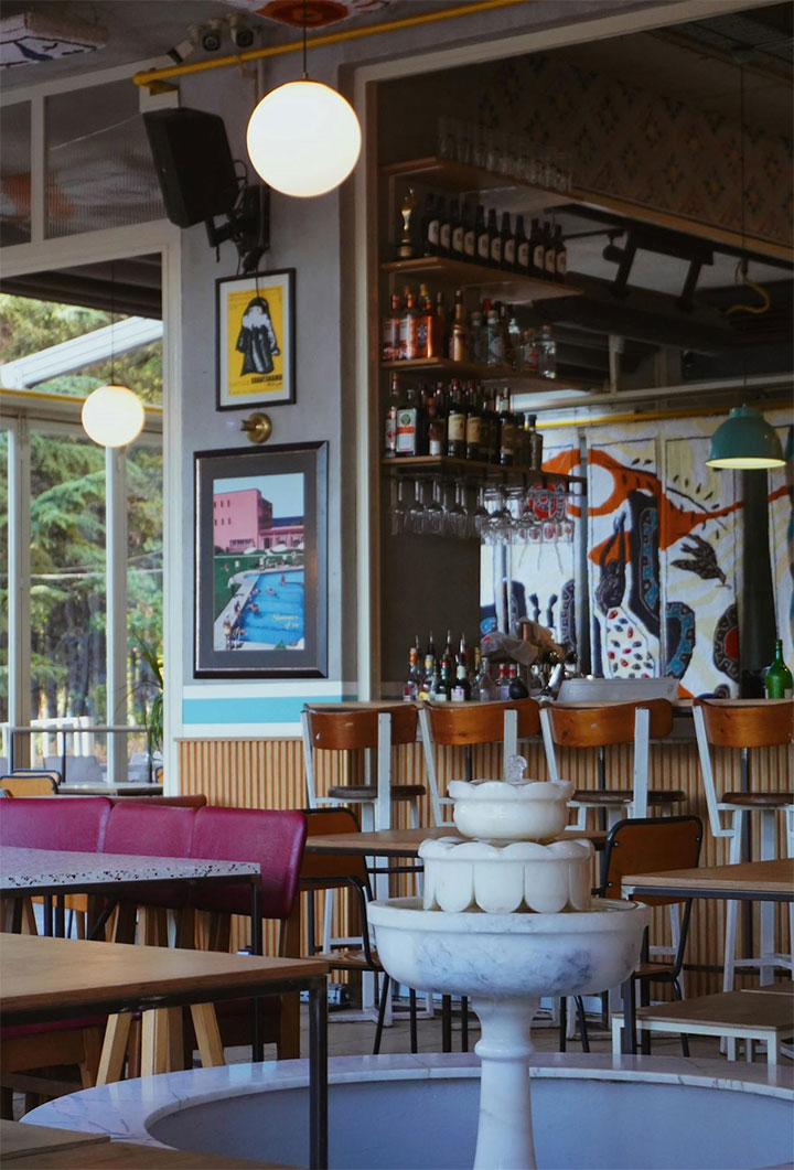Beautiful mix of paintings and sculptures in casual dining area.