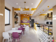 Cozy boba tea store design with bright yellow accents.