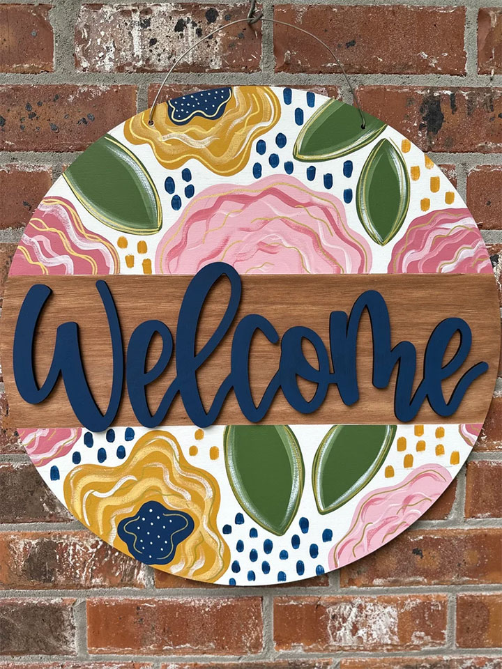 Welcome sign with floral pattern.