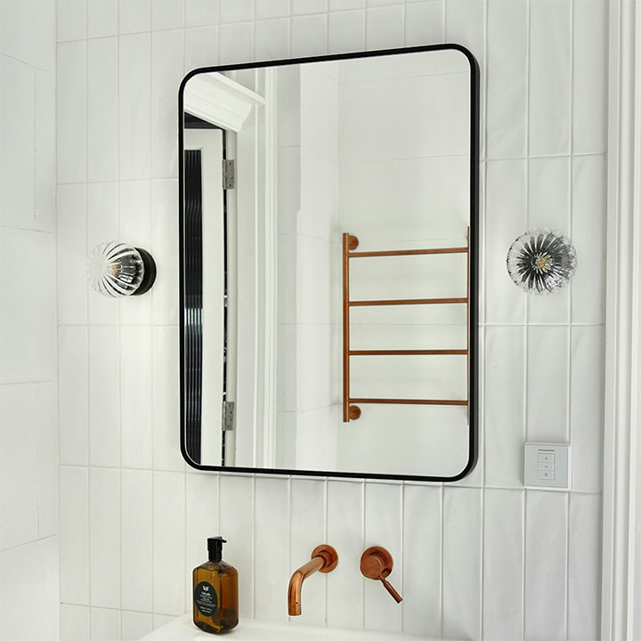 Copper used as an accent metal in minimalist bathroom design.