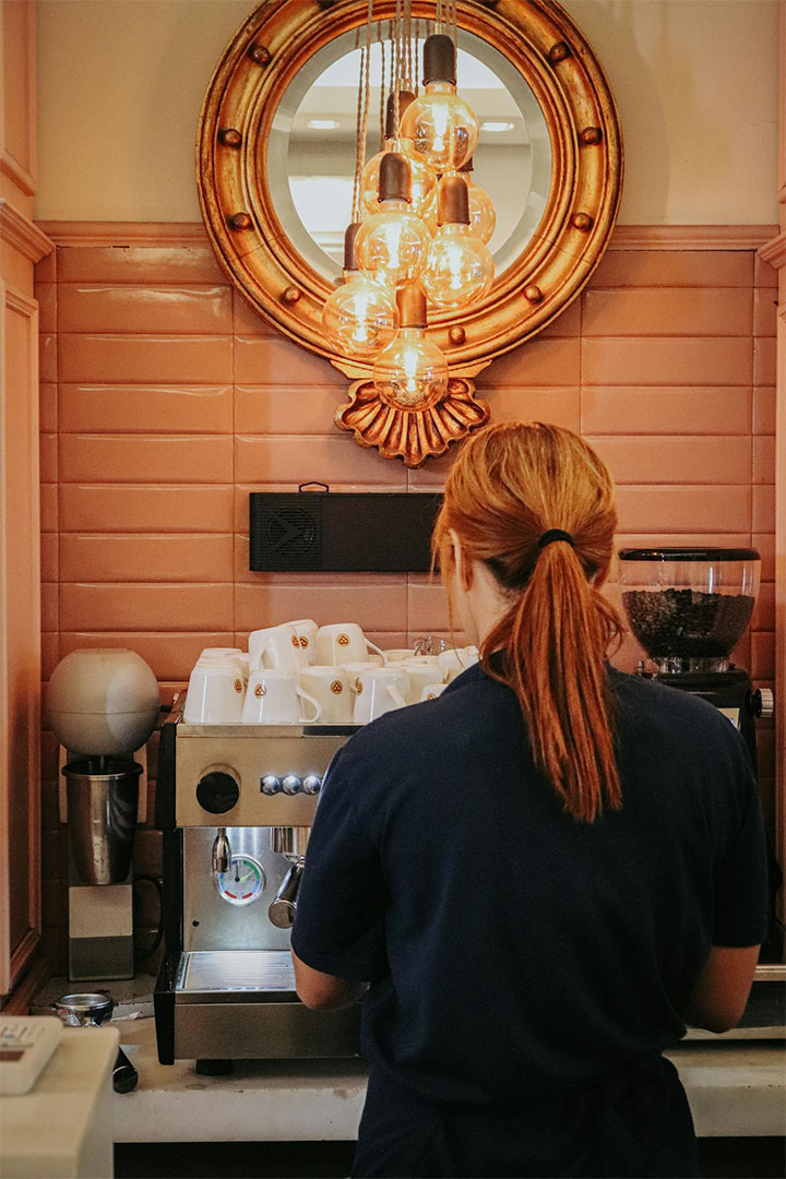 Mirror that uses copper as an accent metal in coffee shop design.