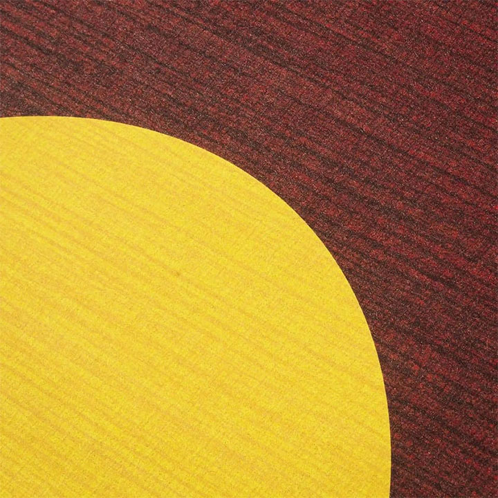 Geometric-patterned ceiling tile in warm colors.