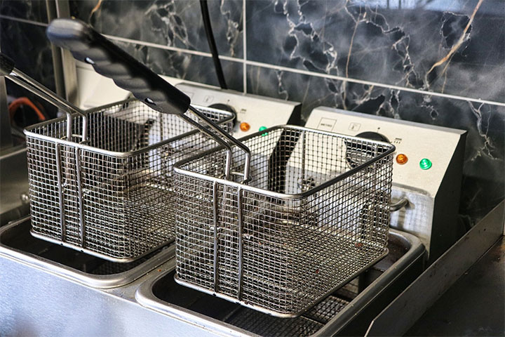 Deep fryers with clean baskets.