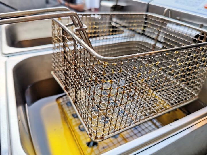 The basket of an open-pot commercial fryer.