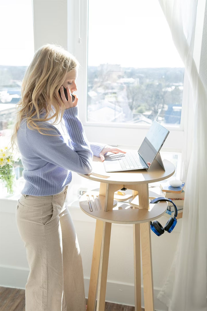 Cozy workspace with standing desk by the window.