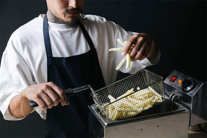 Man cooking French fries.