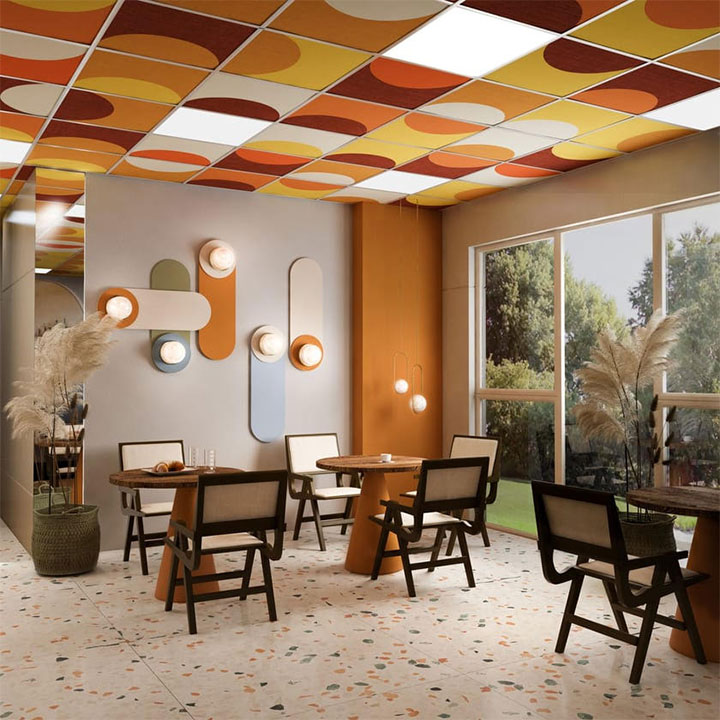 Restaurant interior with colorful ceiling tile design.