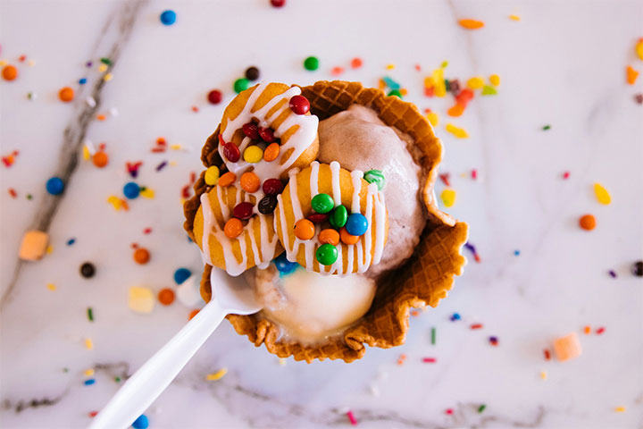 M&Ms and donuts as toppings for an ice cream cone.