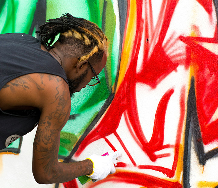 Artist painting a wall.