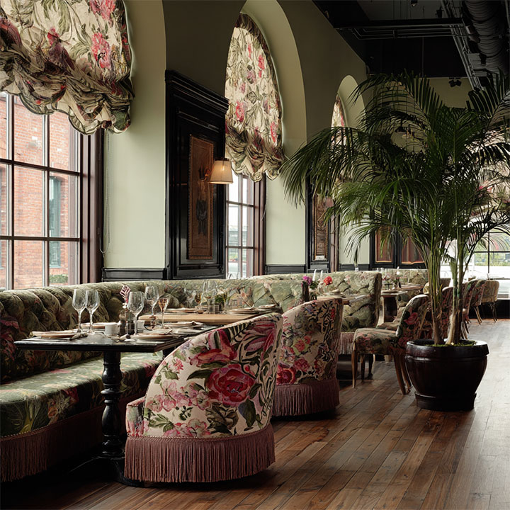 Restaurant interior with bohemian vibes and eclectic furniture.