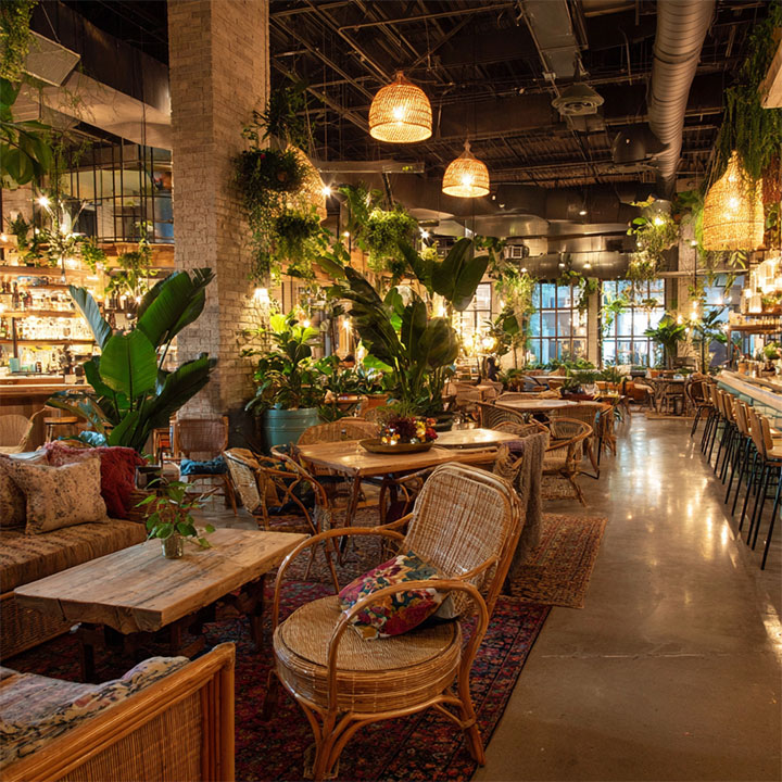 Layered lighting in restaurant interior with boho vibes.