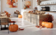 Restaurant fall decor with pumpkins and mums.