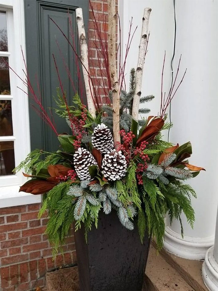 Festive Christmas greenery arrangement at the entrance of a business.