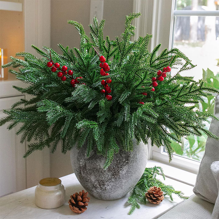 Lush bouquet of pine stems in a Christmas arrangement.