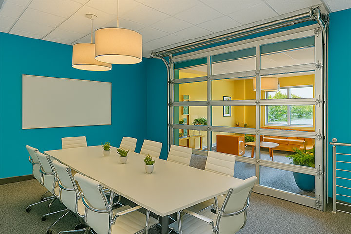 Roll-up glass door between conference room and office.