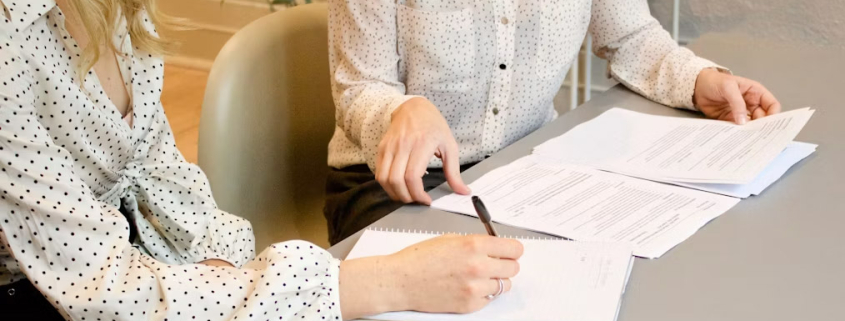 Woman signing restaurant lease