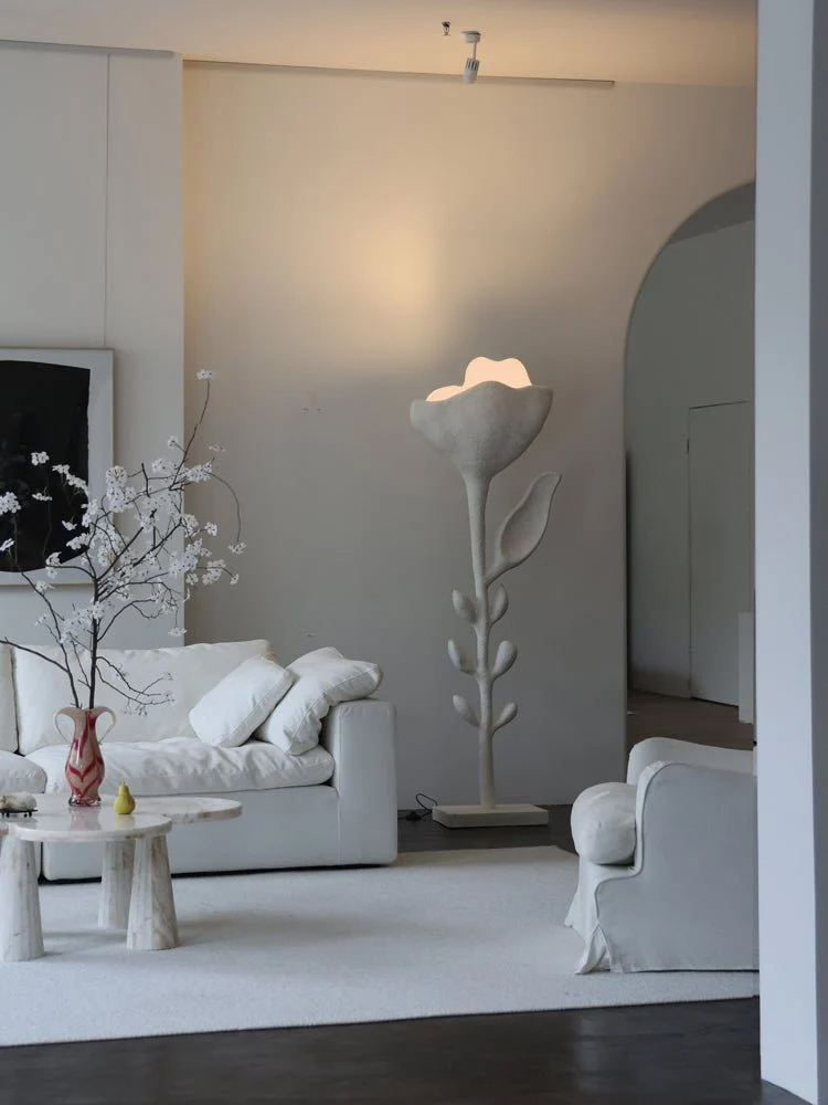 Flower-inspired, architectural floor lamp with white stucco-like finish.